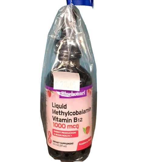 Bottle of liquid supplement with a blue cap on a wooden surface