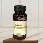 Nature's Sunshine Lobelia supplement bottle on a wooden surface with a blurred blue background